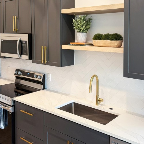 a kitchen with black cabinets