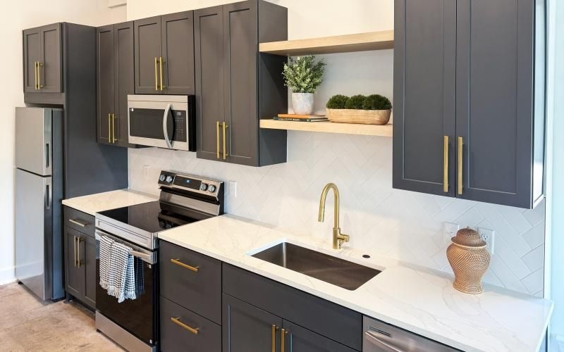 a kitchen with black cabinets